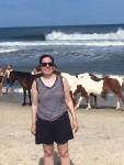 Me with Assateague Ponies, the requisite bus length away.